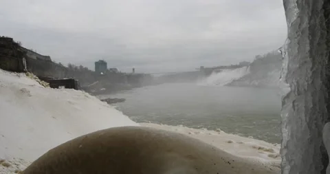 Underneath Niagara falls looking out towards the American falls icicle and water Video stock 229599687