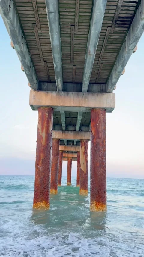 Underneath Ocean Pier With Rusted Structure and Barnacles Stock Footage 337865227