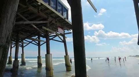 Underneath a pier on a beach during the day Stock Footage 68323091