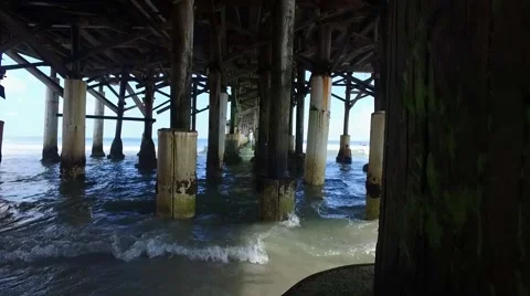 Underneath a pier on a beach during the day Stock Footage 68323097