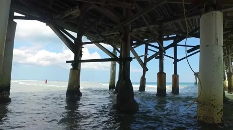 Underneath a pier on a beach during the day Stock Footage 68323102