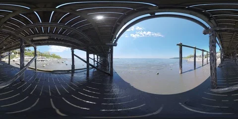 Underneath the pier while the waves come in and out - 360 VR Video stock 90437178