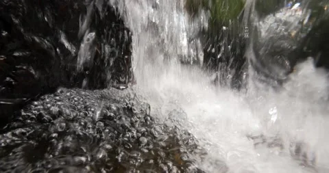 Underneath a small waterfall. Water torrenting on boulders. P2080179 Stockbeeldmateriaal 238068950