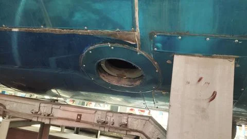 Underneath view of a blue structure with a circular opening, possibly part .. Stock Photos