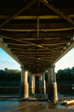 Underneath view of a historic bridge over river in London Stock Photos