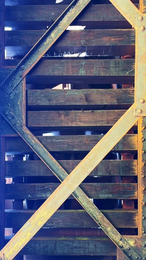 Underneath view of a train passing over the wooden tracks Stock Footage 341979547