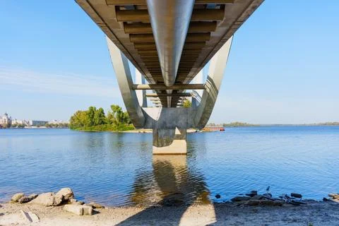 Underneath The Wave Bridge Over The Dnipro River In Kyiv On A Clear Sunny Day Stock-Fotos