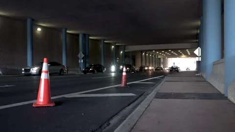 Underpass traffic congested at an intersection with construction cones Stock Footage 303791356