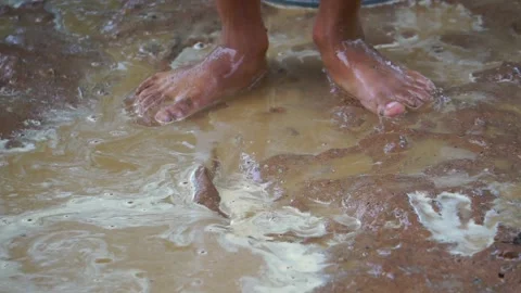 Underprivileged children happily playing in muddy water Stock Footage 158887202
