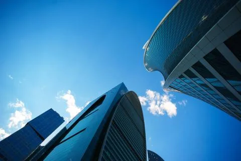 Underside angle view to background of modern glass building skyscrapers over Stock Photos