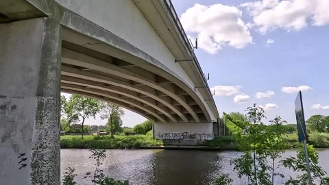 Underside of a bridge on the water in daylight. Stock Footage 242860823