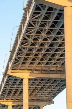 Underside of a cable-stayed bridge with sunlight reflecting on the Stock Photos