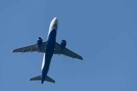 Underside of a commercial jet in flight Stock Photos