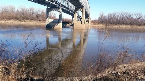 Underside of dual bridges spanning river tilt shot Stock Footage 87258323