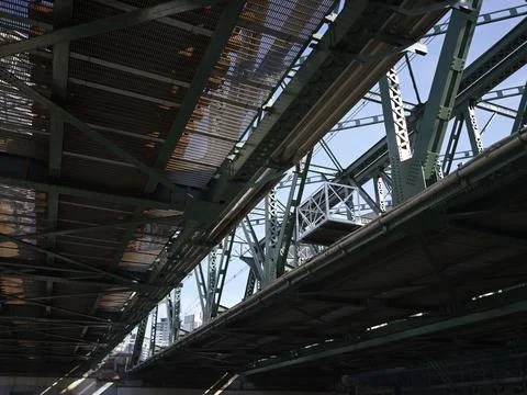 The underside of green steel elevated railway girders, Japan Stock Photos