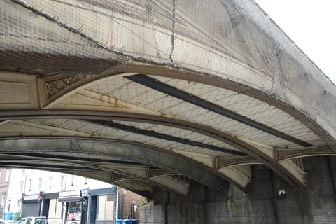 Underside Of Historic Bridge With Protective Netting And Urban View, Derby, Stock Photos