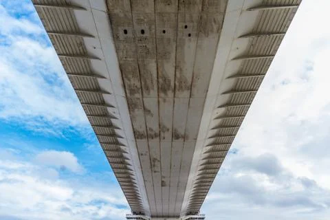 Underside of large road suspension bridge, landscape. Stock Photos