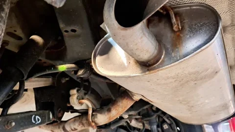 Underside Vehicle View Showing Muffler and Rusted Exhaust Pipes 스톡 동영상 331840655