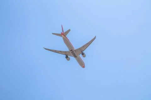 Underside view of a commercial airliner flying Stock Photos