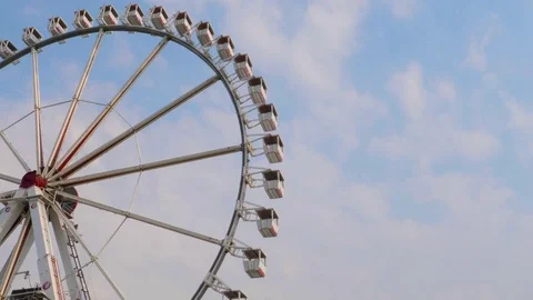 Underside view of a ferris wheel over blue sky Stock Footage 77305101