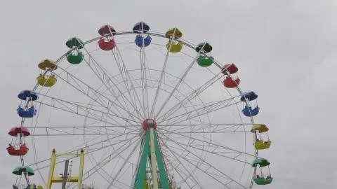 Underside view of a ferris wheel over blue sky. Stock Photos