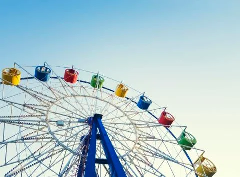 Underside view of a ferris wheel over blue sky Stock Photos