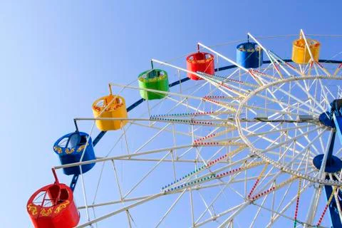 Underside view of a ferris wheel over blue sky Stock Photos