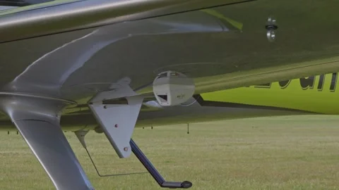 Underside Wing Green Cirrus SR22 G7 Ultralight Aircraft Slow Motion Stock Footage 304094160