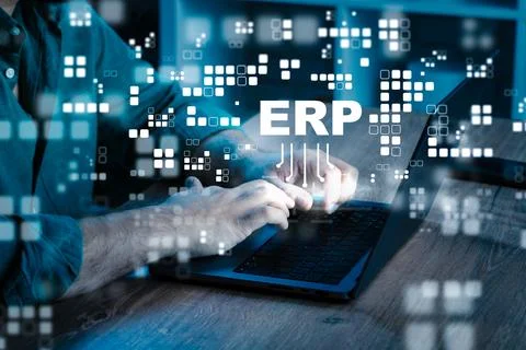 Understanding ERP systems through hands-on work at a laptop in a modern office Stock Photos