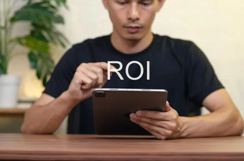Understanding Return on Investment through Digital Devices in Focus Stock Photos