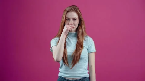 The understanding young redhead swears to keep a secret by locking her mouth and Stock Footage 152534669