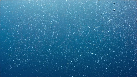 Underwater abstract shot of shimmering bubbles in open blue water Stock Footage 342600259