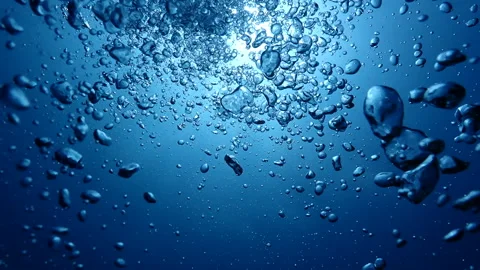Underwater air bubbles rising from deep water up to the surface in tropical sea Video stock 248068376