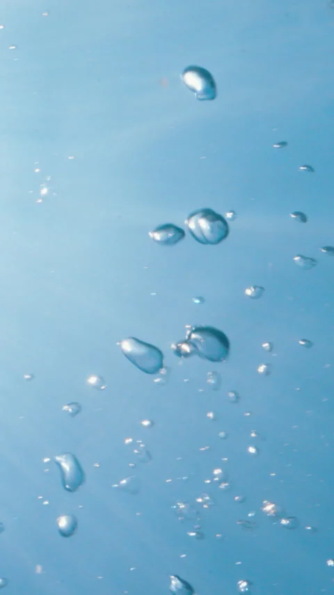 Underwater air bubbles rising from deep water up to the surface in tropical sea Stock Footage 284003697