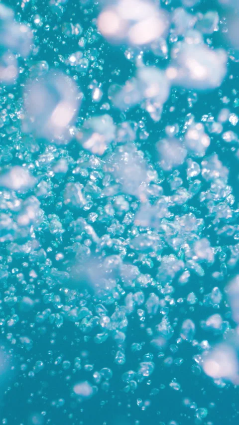 Underwater air bubbles rising from deep water up to the surface in tropical sea Stock Footage 284006054