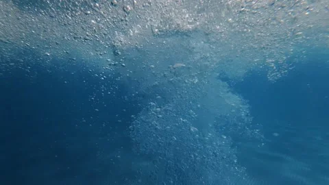 Underwater air bubbles rising toward pool surface in blue water Stock Footage 342048879