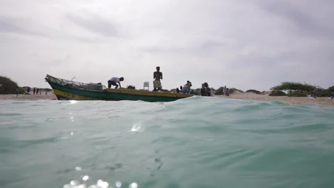 Underwater and Water Surface View of People in Boat by Sandy Beach of Cape Verde Stock Footage 342276880