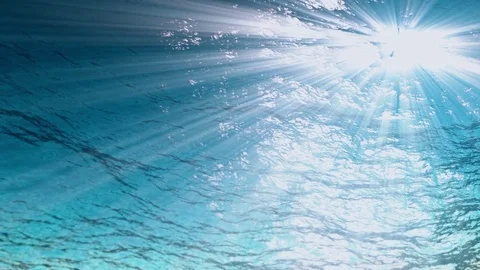 Underwater background,Rays of light make their way through ocean waves from Stockbeeldmateriaal 84866920