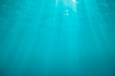 Underwater blue background with sun rays Stock Photos