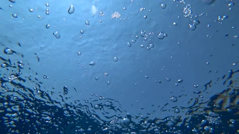 Underwater bottom view on of air bubbles rising and meeting surface Stock Footage 137838258
