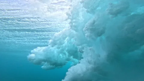 UNDERWATER: Breaking wave turns into cloud of foam and bubbles in tropical water Stock Footage 339083866