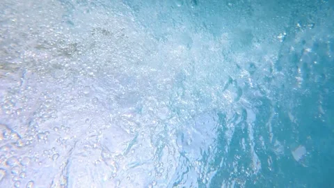 Underwater bubbles churning near surface in swimming pool Stock Footage 342160362
