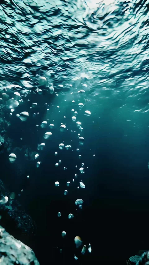 Underwater bubbles gently rising above the rocky seafloor in a serene marin.. Stock Footage 300725862