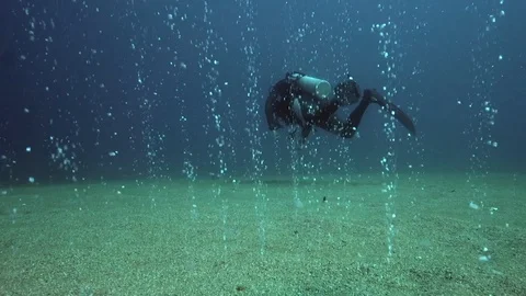 Underwater bubbles is going up from the sandy bottom Stock Footage 89595870