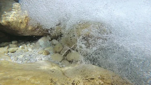 Underwater bubbles from a mountain river, pure water. Super slow motion Stock Footage 94449040