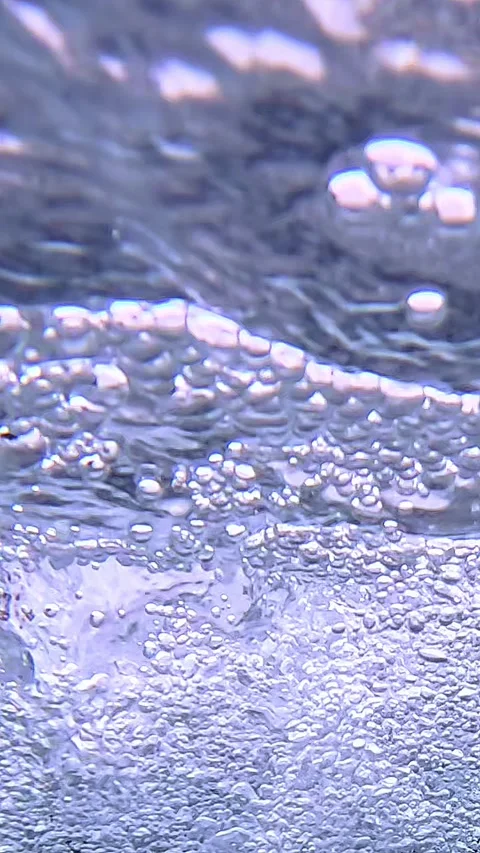 Underwater bubbles rising in clear liquid with shimmering motion Stock Footage 318068230