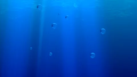 Underwater bubbles rising in deep blue ocean with sun rays for world water day Stock Footage 327050519