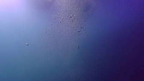 Underwater Bubbles Rising in Deep Blue Ocean Water with Sunlight Видео 334502081