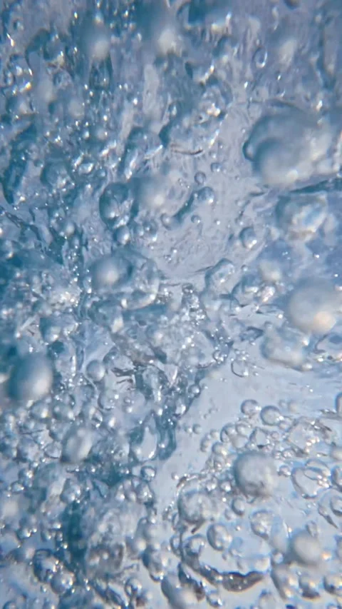 Underwater bubbles rising through clear pool water during daytime Stock Footage 342159720