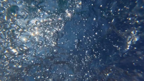 Underwater bubbles rising toward the swimming pool surface in daylight Stock Footage 342049082